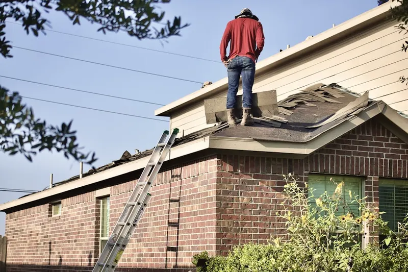 Professional roofer working on a residential roof in Camano